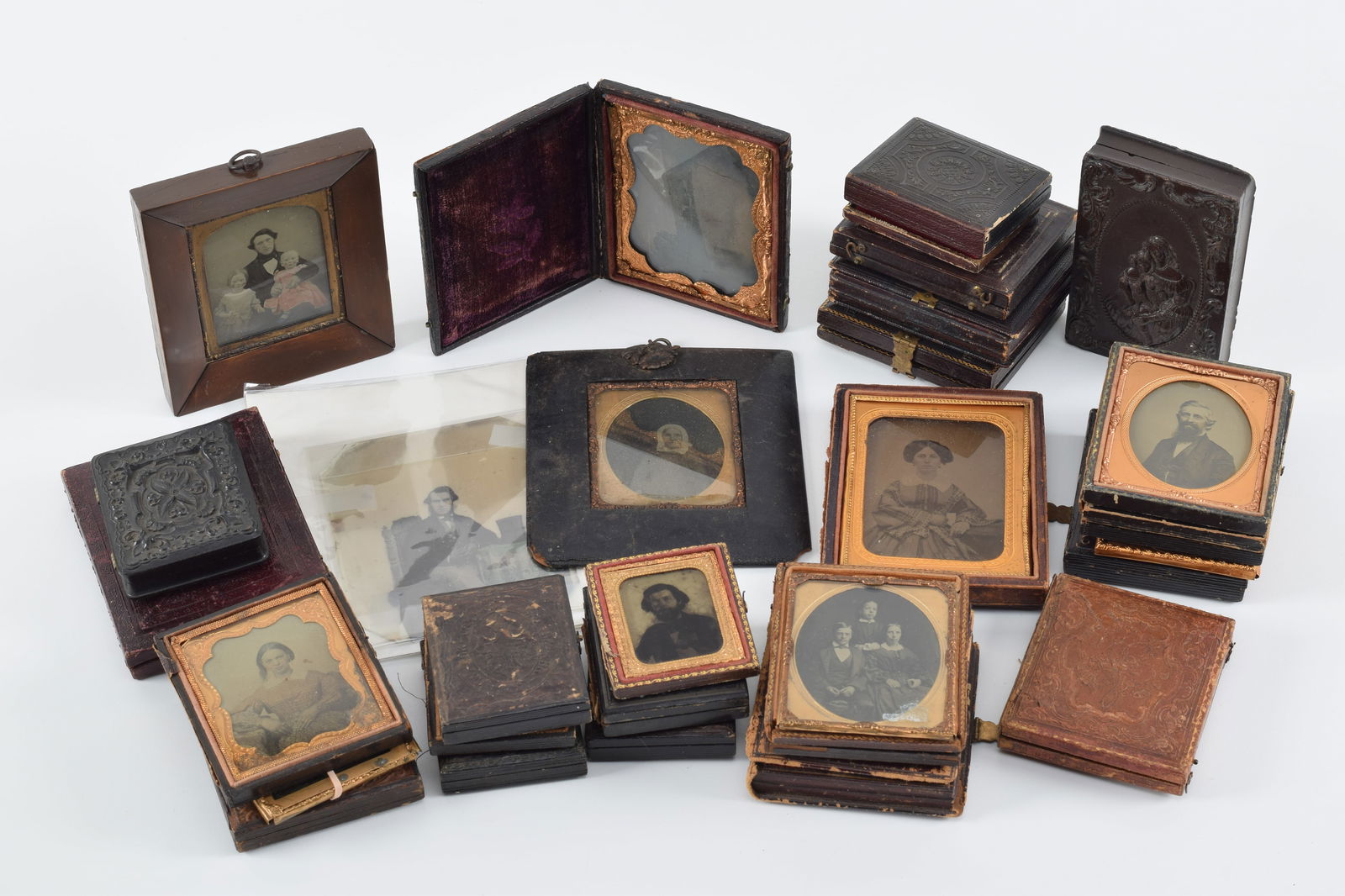 Lot of 30 ambrotype photographs. Includes a charming tinted image of a father with his two girls, (1 of 17)
