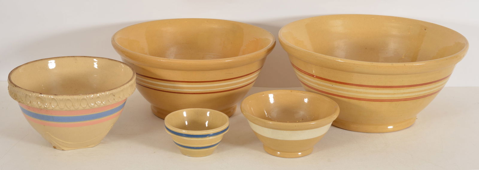 Collection of 5 yellow-ware mixing bowls in graduated sizes. Larges diameter 17 in. Some flaws (1 of 7)