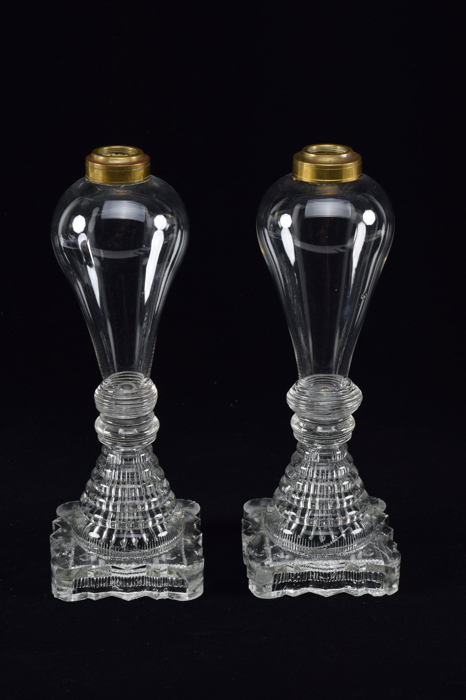 Pair of Sandwich glass whale oil lamps, mid 19th Century. Blown fonts on waterfall base. Some wear: Pair of Sandwich glass whale oil lamps, mid 19th Century. Blown fonts on waterfall base. Some wear and chips at base. No elements. Height 10.25in