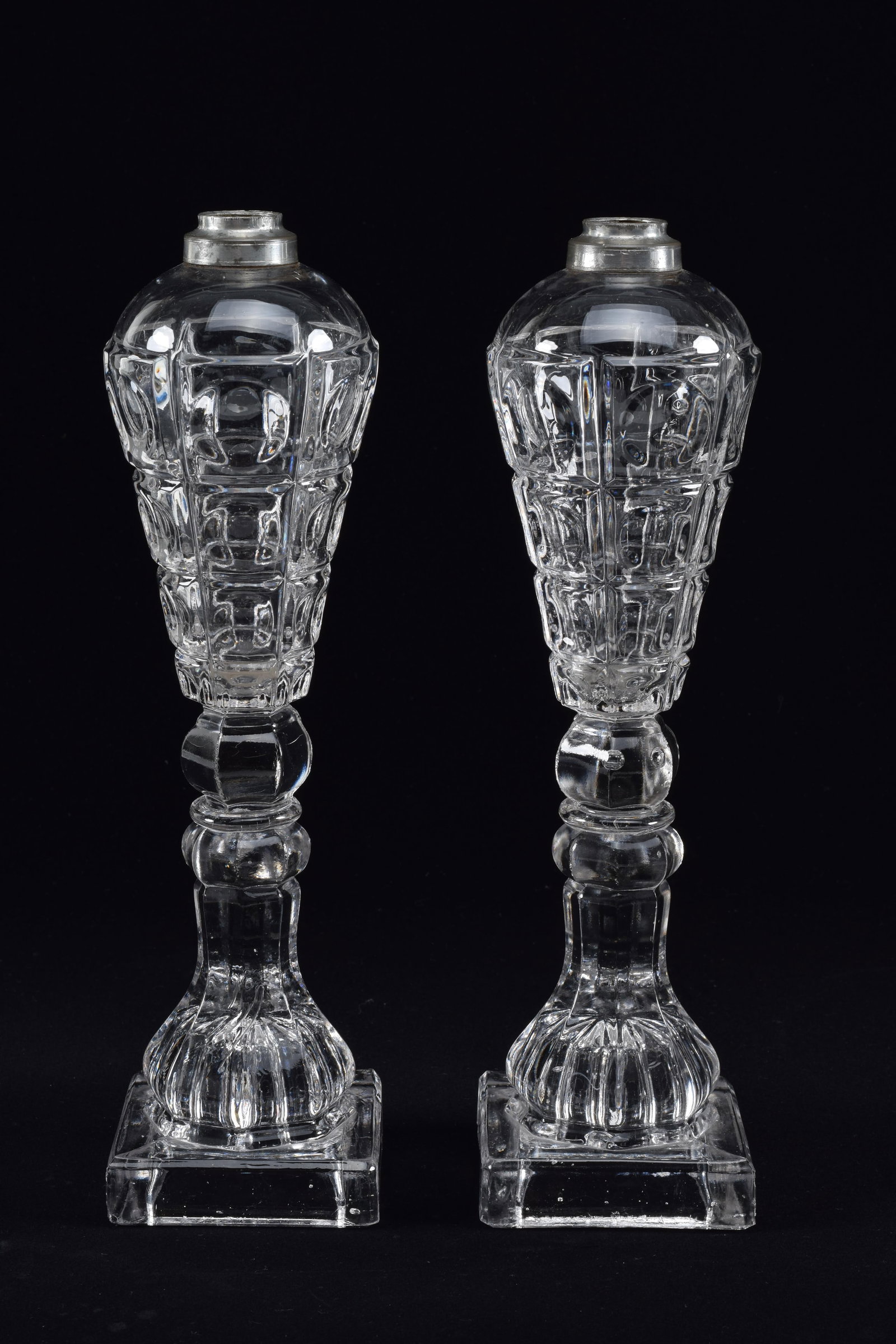 Pair of tall whale oil lamps with faceted and thumbprint pattern, mid-19th Century. Roughness at: Pair of tall whale oil lamps with faceted and thumbprint pattern, mid-19th Century. Roughness at base edges, no elements. Height 11in