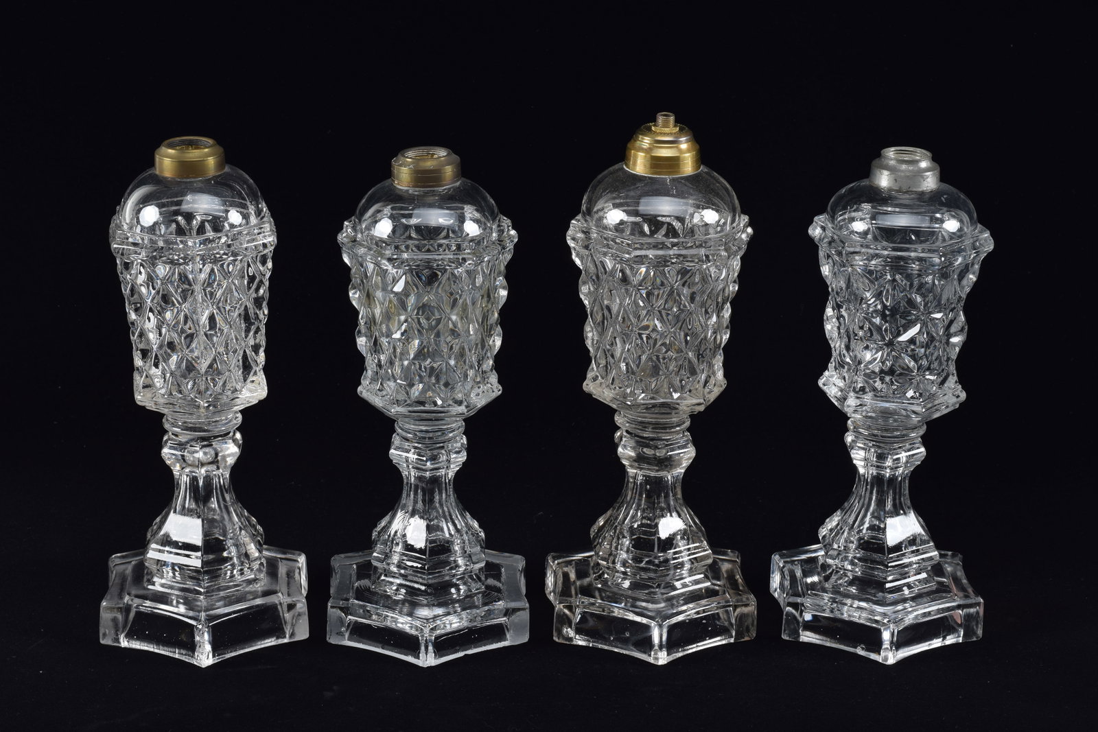 Set of 4 Flint glass whale oil lamps, mid 19th Century. Flattened sawtooth pattern. Height 11in: Set of 4 Flint glass whale oil lamps, mid 19th Century. Flattened sawtooth pattern. Height 11in