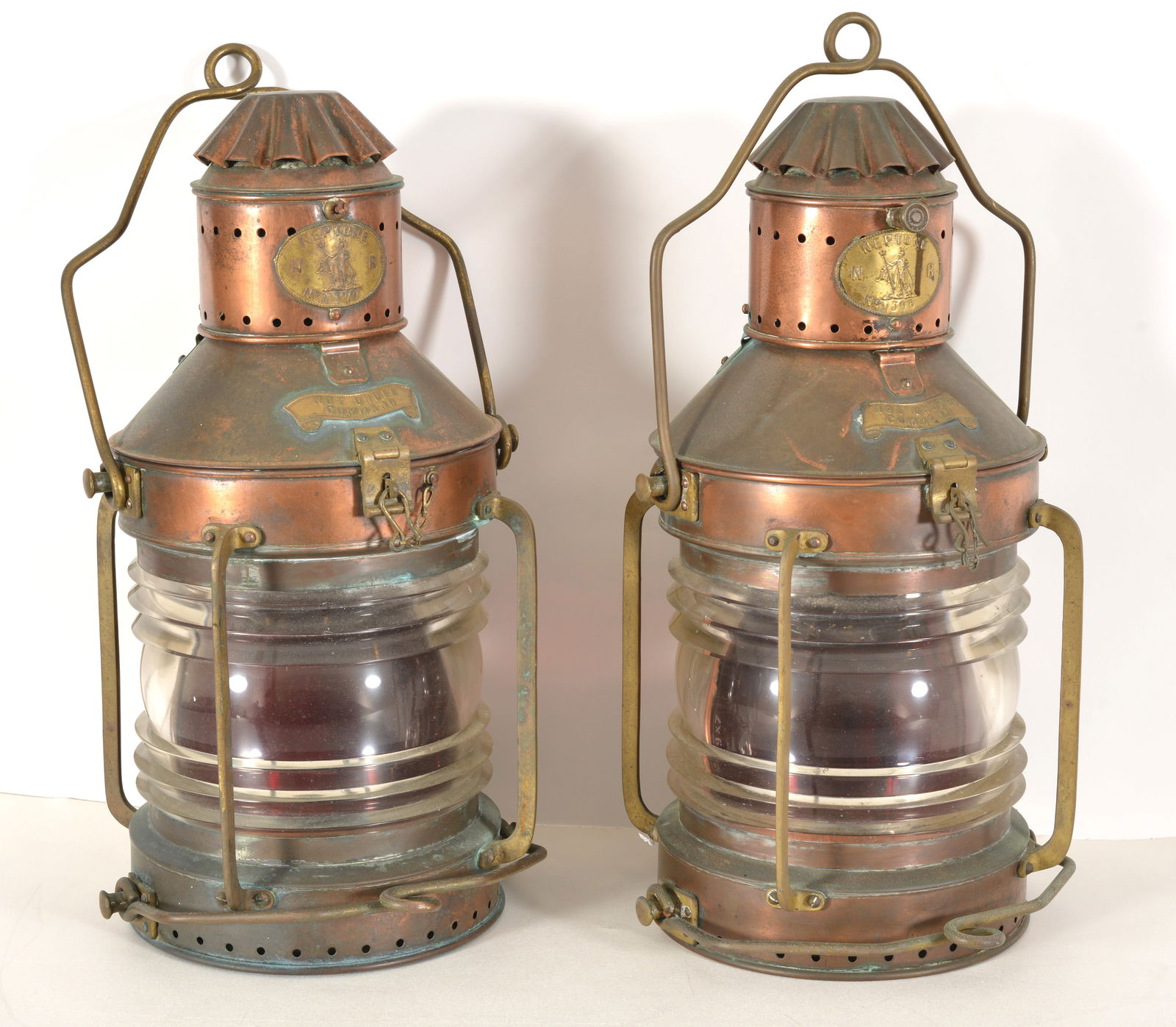 Pair of Neptune copper ship's anchor lanterns with molded glass and two handles. Fitted as lamps. (1 of 8)