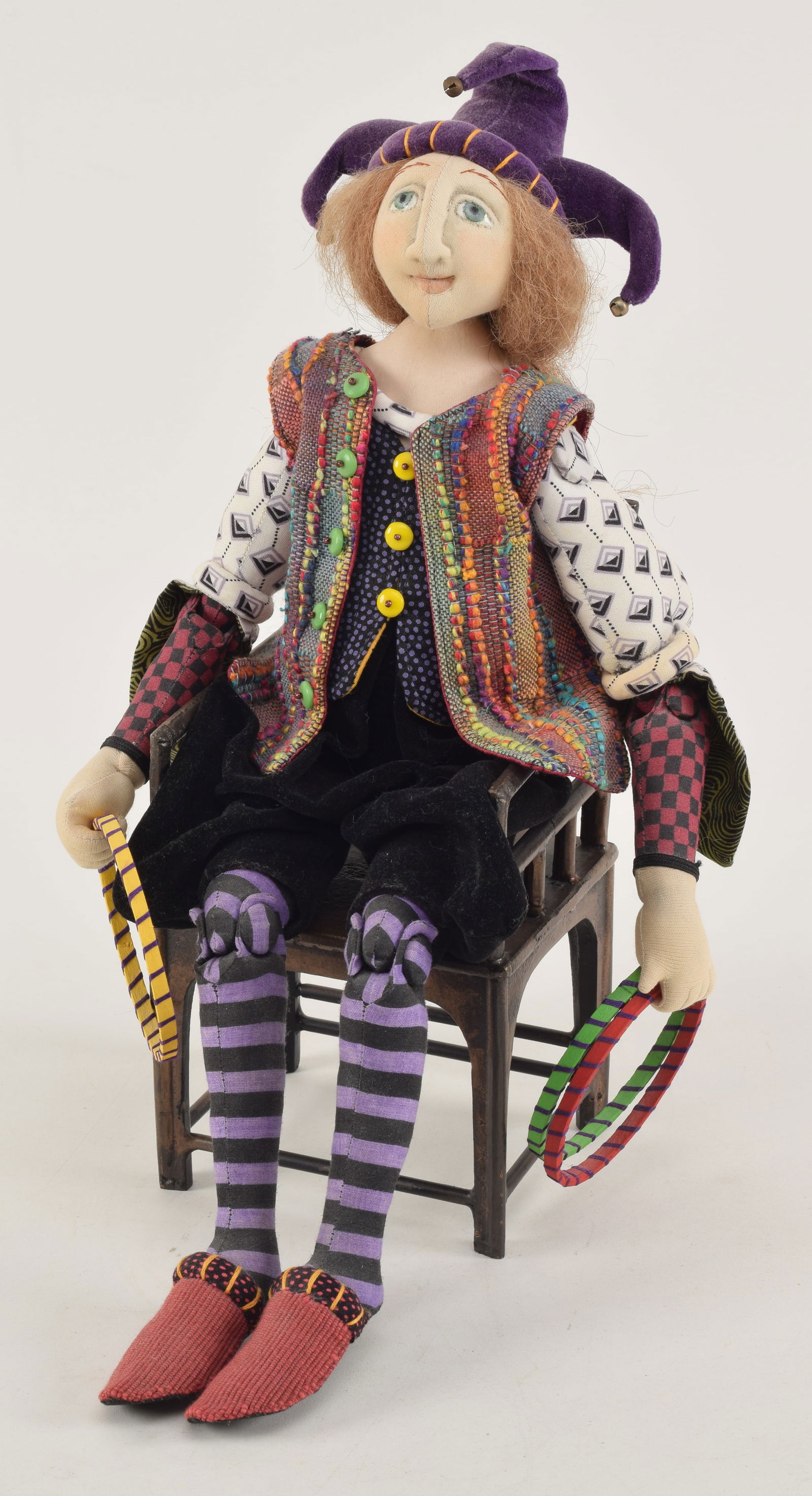 Akira Blount jester doll with cast metal chair. Jester dressed in colorful outfit holding several (1 of 4)