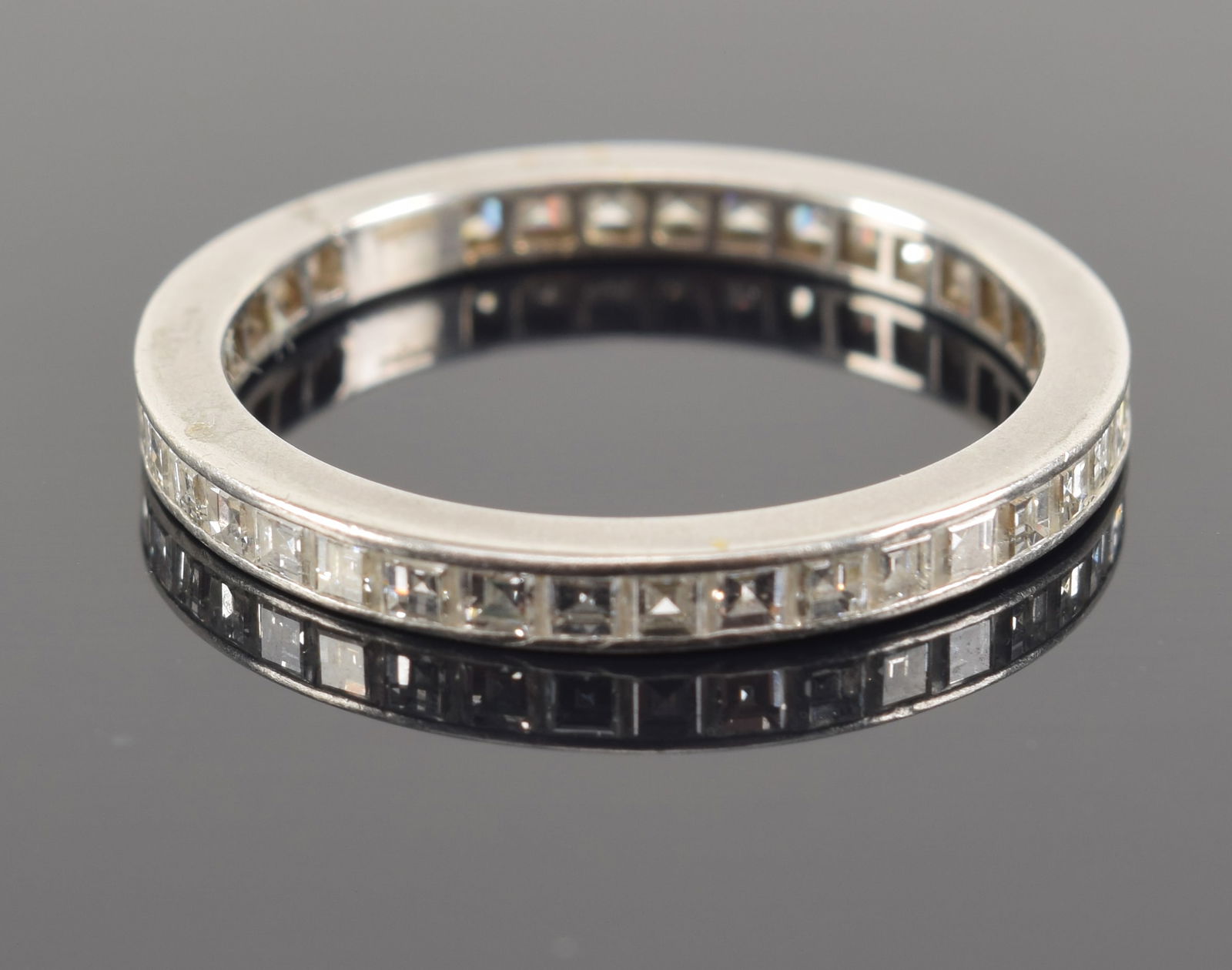 Vintage platinum diamond mounted anniversary ring band. Channel set square cut diamonds. Area of (1 of 4)