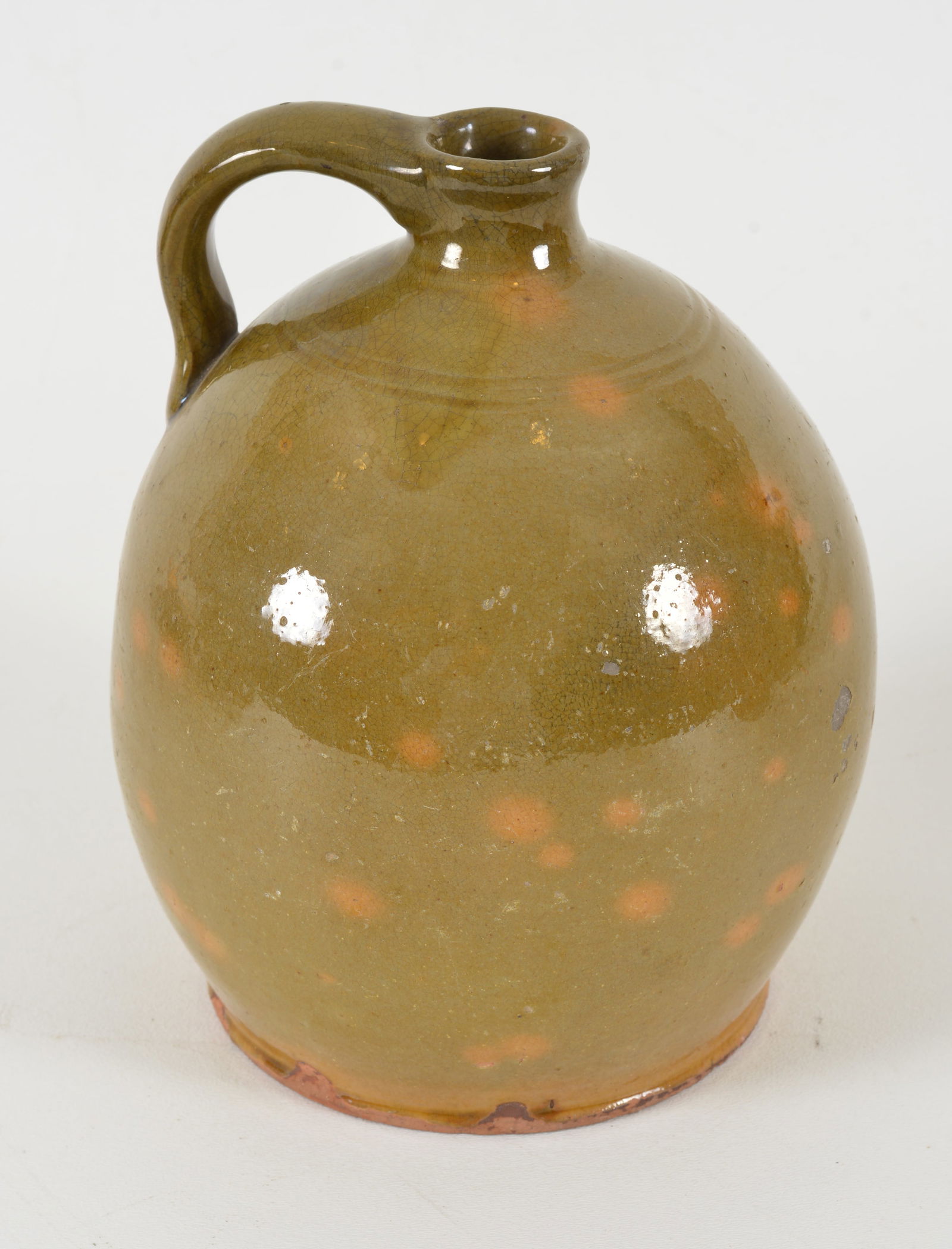 Redware glazed handled jug with green glaze and yellow mottling, 19th Century. Some pitting in (1 of 6)