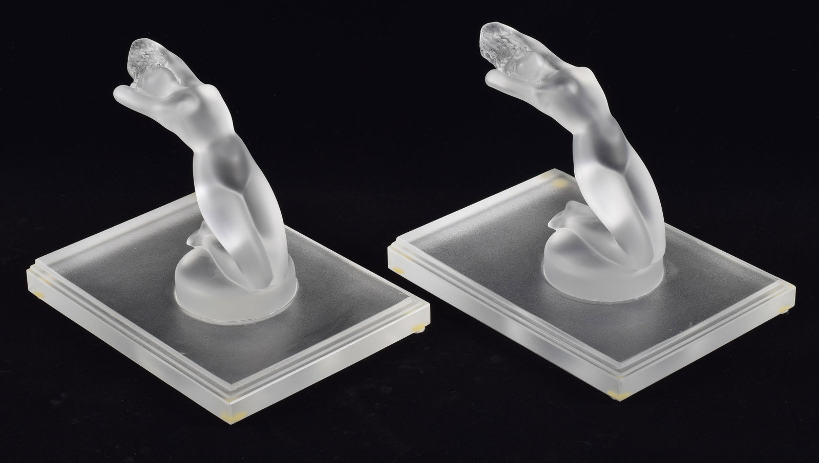 Pair of Lalique frosted crystal "Chrysis" kneeling nude figures on stepped bases. Marked Lalique: Pair of Lalique frosted crystal "Chrysis" kneeling nude figures on stepped bases. Marked Lalique France on base. 7.5 x 6 x 6in.