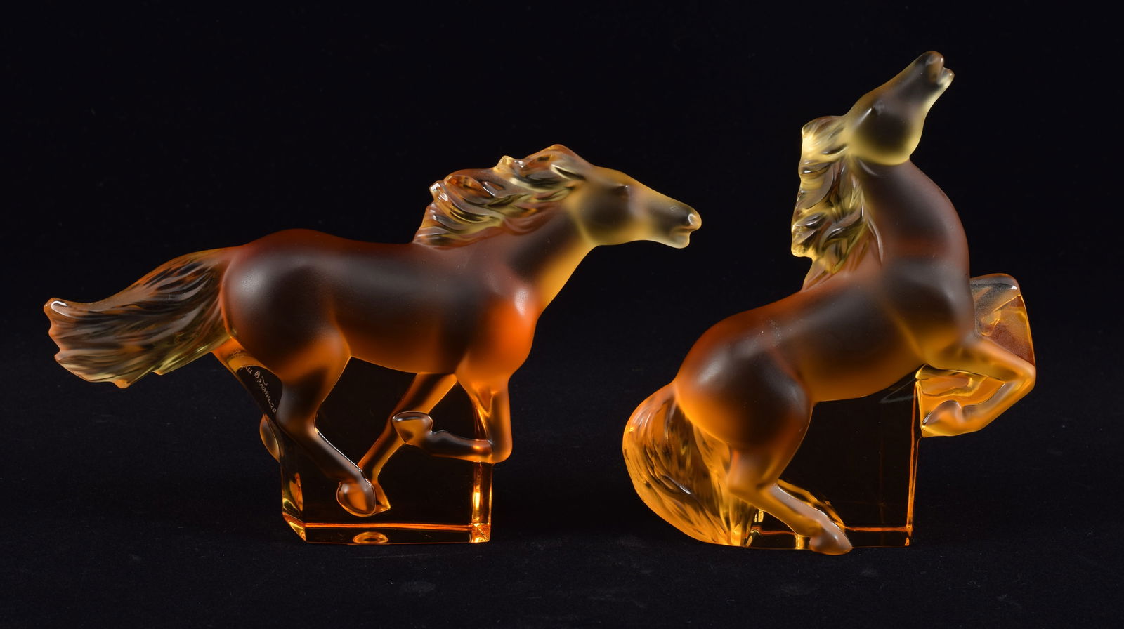 2 Lalique amber colored crystal horse figurines. Each marked Lalique France. Largest: 6.75in wide. (1 of 4)