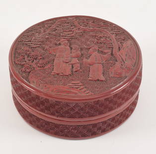 Cinnabar box. China. 19th century. Round form. Surface carved with a gathering of scholars. 4in: Cinnabar box. China. 19th century. Round form. Surface carved with a gathering of scholars. 4in diameter.