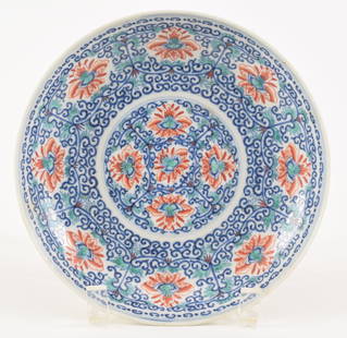 Tou tsai saucer dish. China. 18th century. Decoration of stylized lotus scrolling. Overglaze enamel: Tou tsai saucer dish. China. 18th century. Decoration of stylized lotus scrolling. Overglaze enamel Hsuan Te mark. 7.5in diameter. Age lines.