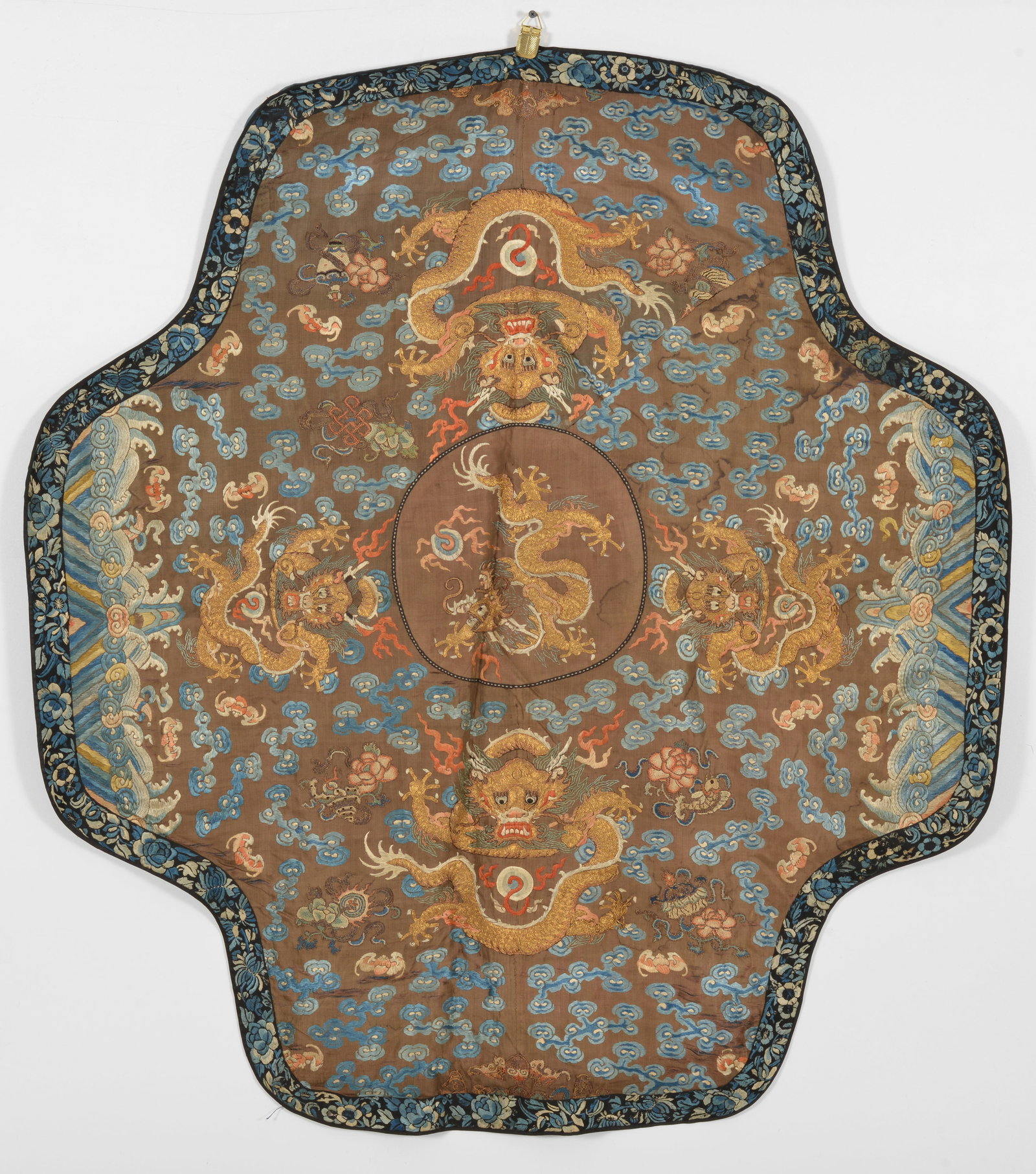 Textile fragment. China. Late 19th century. Embroidery of dragons and clouds on brown ground. (1 of 4)