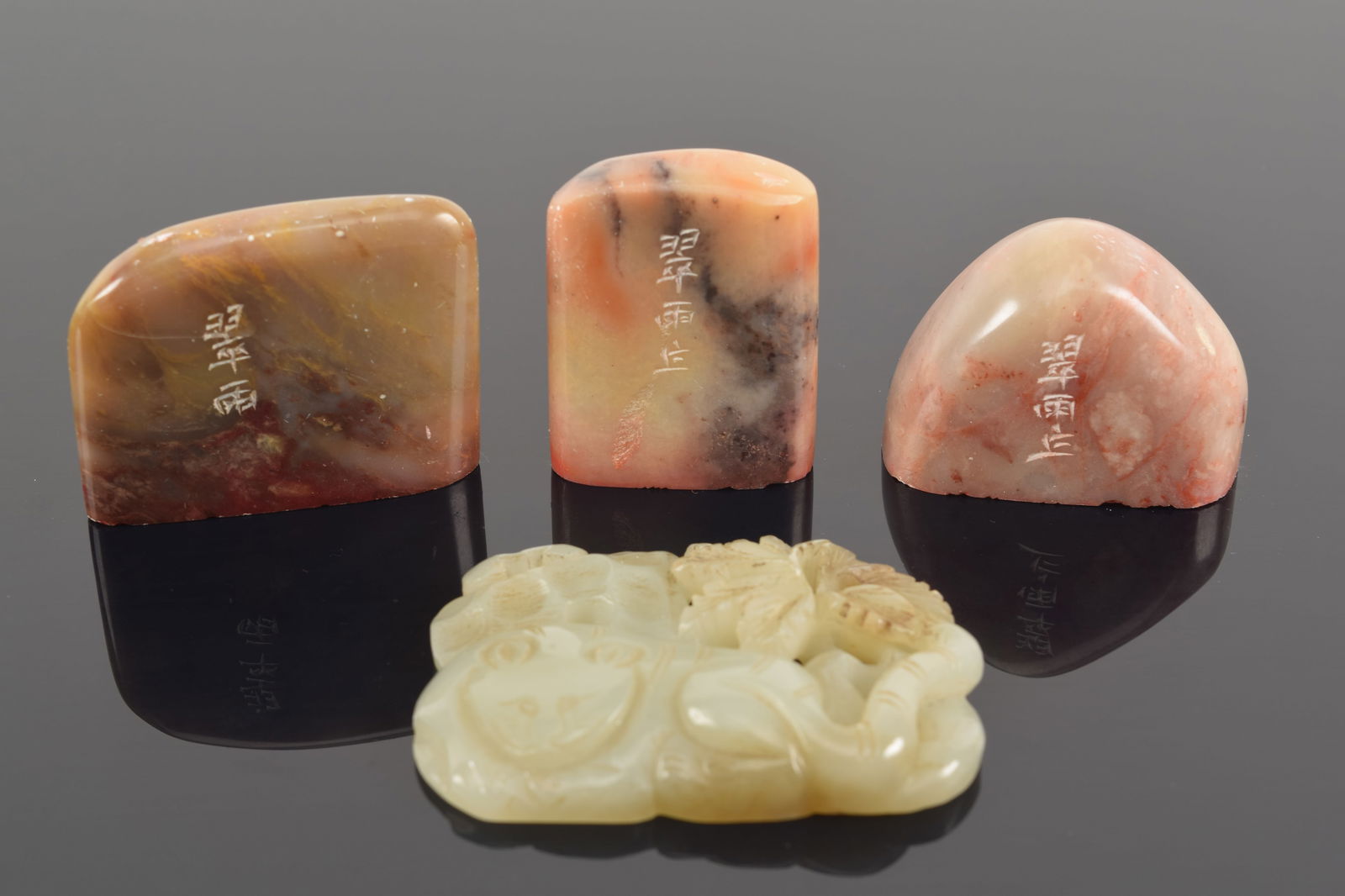 Lot of 4 pieces. China. 19th/20th century. 3 soapstone seals and one jade pendant. Largest 2.25in. (1 of 6)