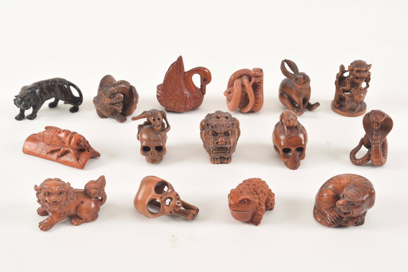 15 carved wooden toggles. 20th century. Various animals and 3 memento mori. Each about 1.5in. (1 of 11)