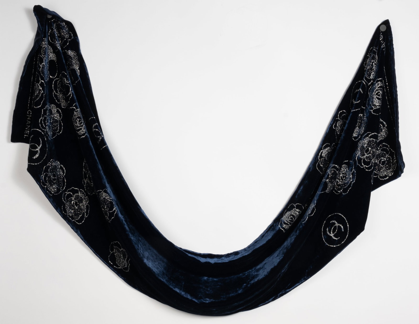 Chanel rayon and silk velvet scarf. 70" x 17". One sided. Deep deep blue with silver studded flower: Chanel rayon and silk velvet scarf. 70" x 17". One sided. Deep deep blue with silver studded flower design on each end.
