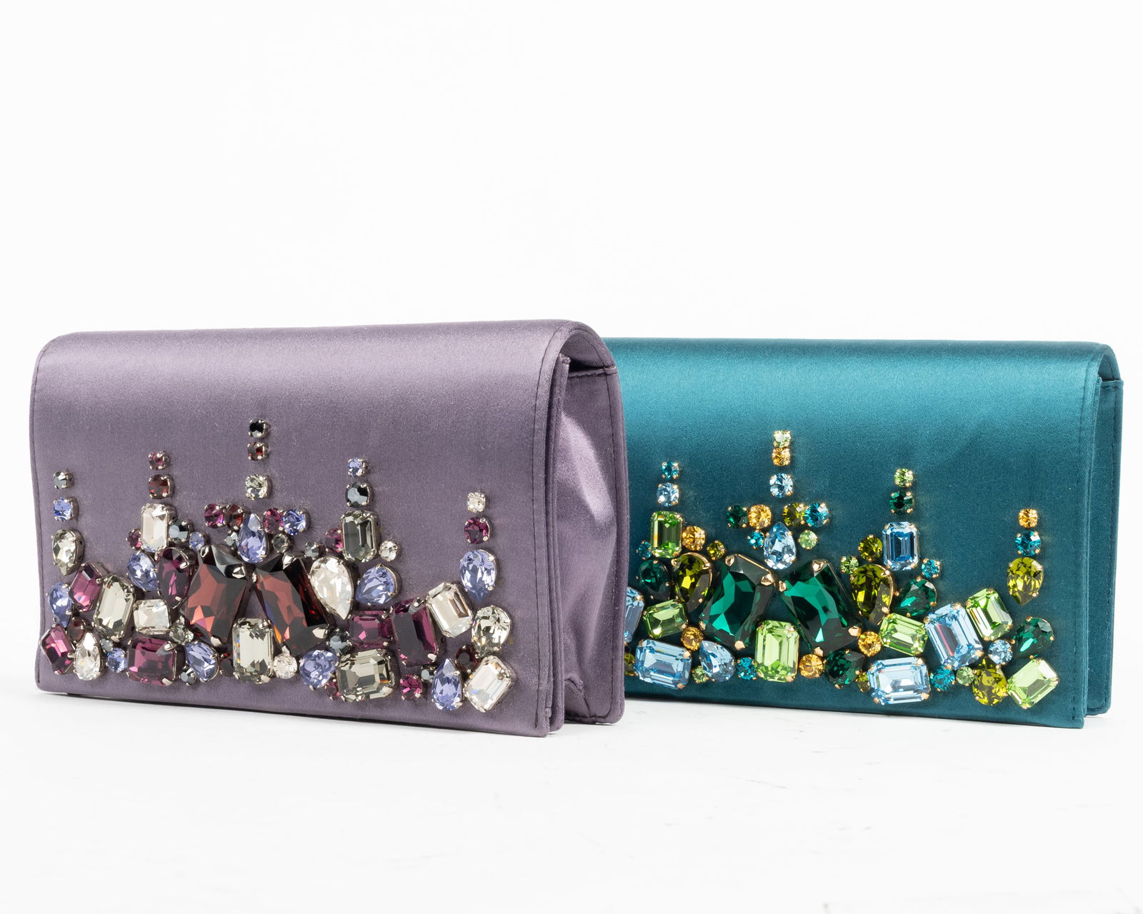 Lot of two Prada jeweled satin clutches. (1) In deep turquoise. The body with topaz, citrine, pale: Lot of two Prada jeweled satin clutches. (1) In deep turquoise. The body with topaz, citrine, pale blue and crystal rhinestones on cover. One interior pocket. Includes small hand mirror. Comes with Pr