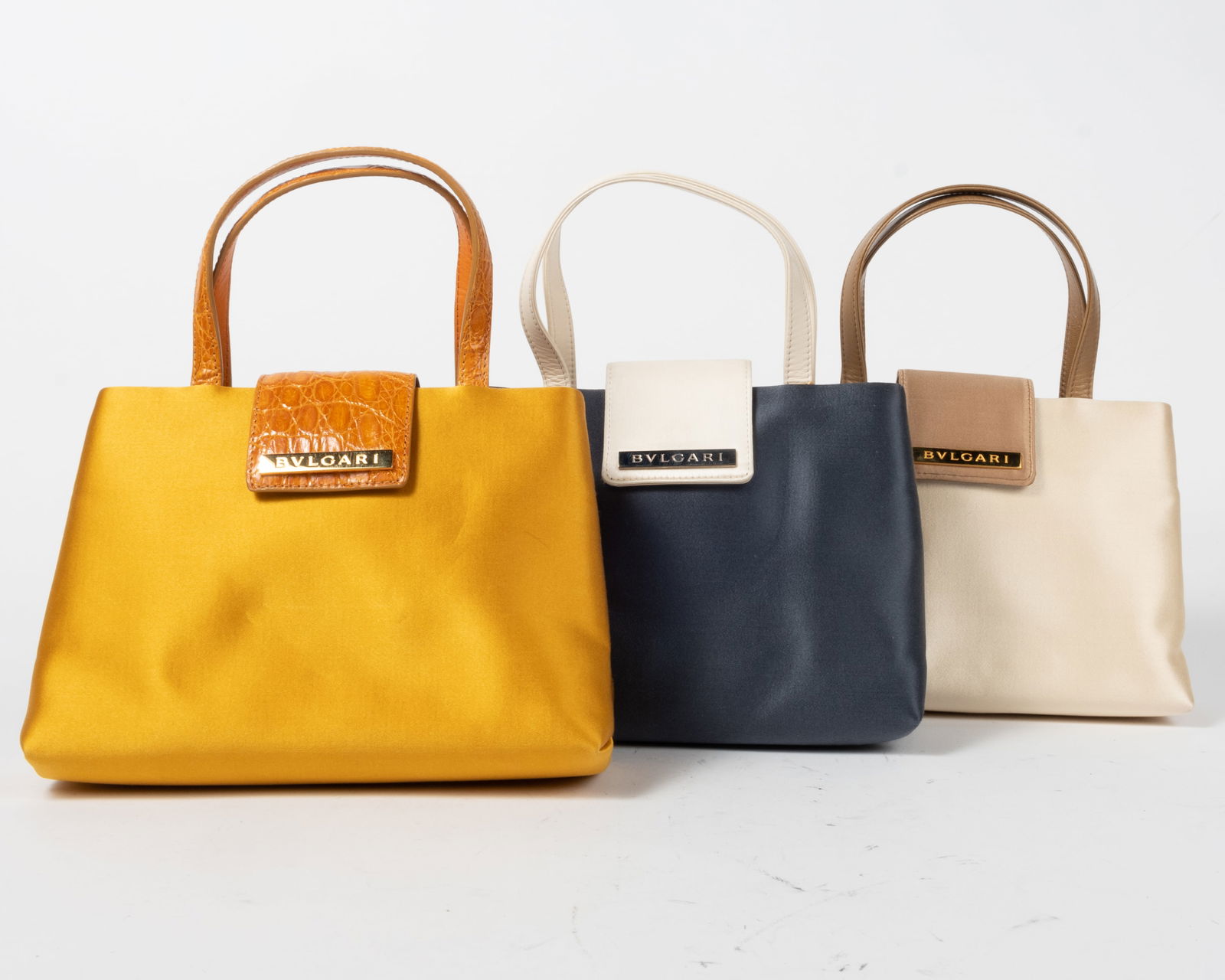 Lot of three Bulgari satin evening bags. All the same size and shape. (1) Ivory with tan trim (2) (1 of 12)