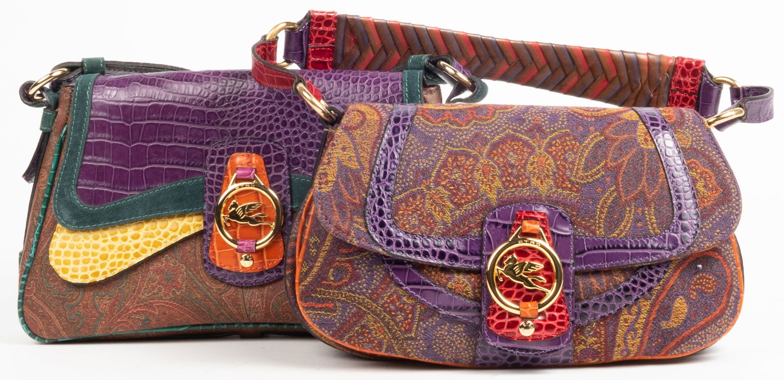 Two ETRO designer handbags. (1) Cloth with crocodile multi colored leather trim and gold metal ETRO: Two ETRO designer handbags. (1) Cloth with crocodile multi colored leather trim and gold metal ETRO logo on clasp. Cloth paisley body. Crocodile leather strap. Purple fabric interior. One zippered int