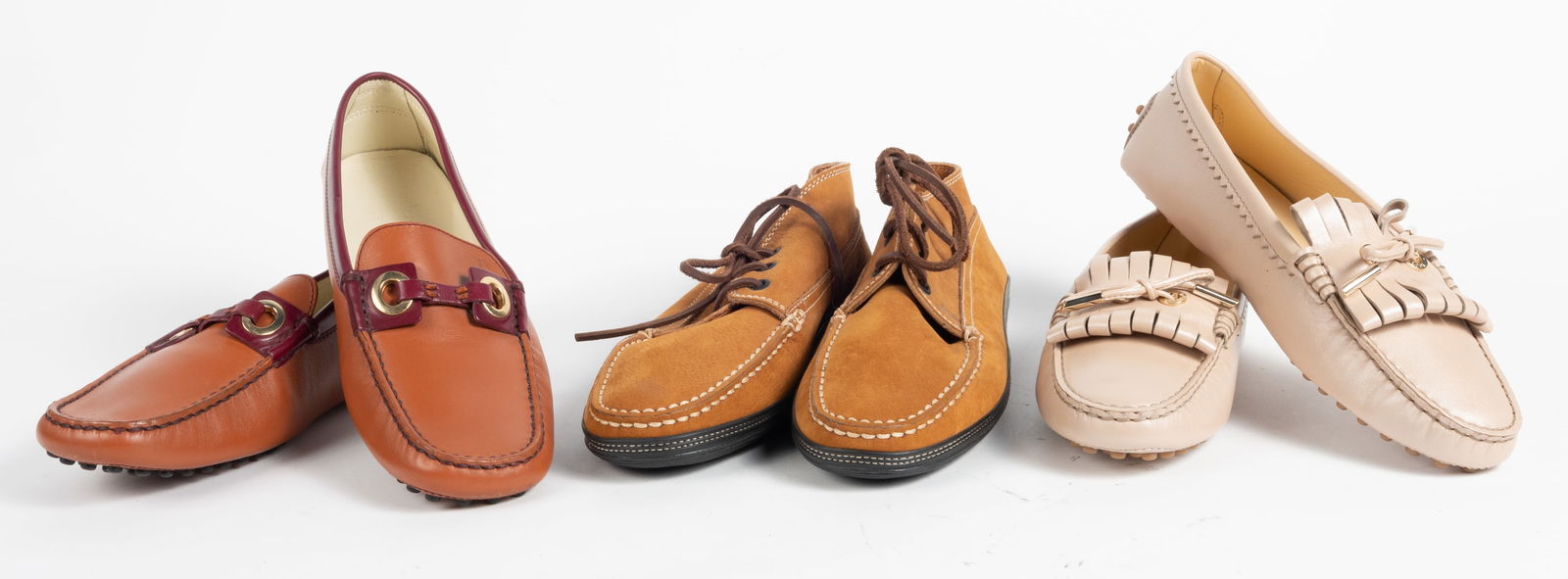 Three pairs of Tod's loafers.(1) Suede lace up moccasins. (size 38-1/2). (2) Metallic champagne with: Three pairs of Tod's loafers.(1) Suede lace up moccasins. (size 38-1/2). (2) Metallic champagne with tassels (size 38). (3) Horse bit leather with buckles (size 8-1/2). Never worn condition.
