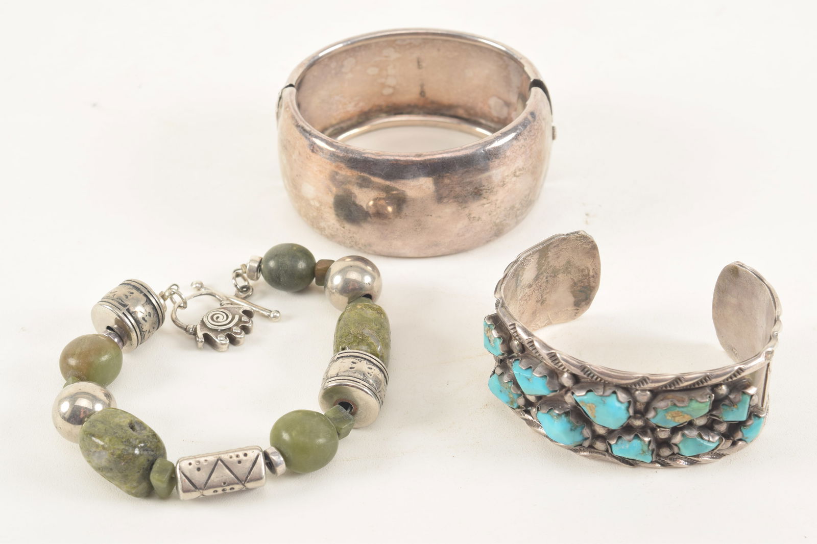 3 Silver bracelets, one with British sterling marks the others unmarked in southwestern designs. 4.1 (1 of 6)
