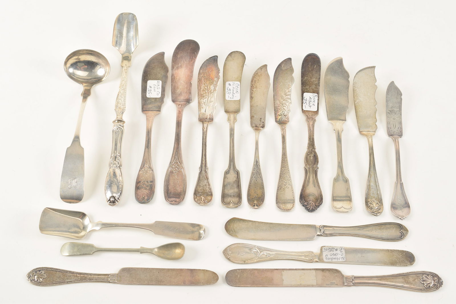 18 Coin silver serving items including ten butter servers, four butter spreaders, a sugar scoop, (1 of 6)