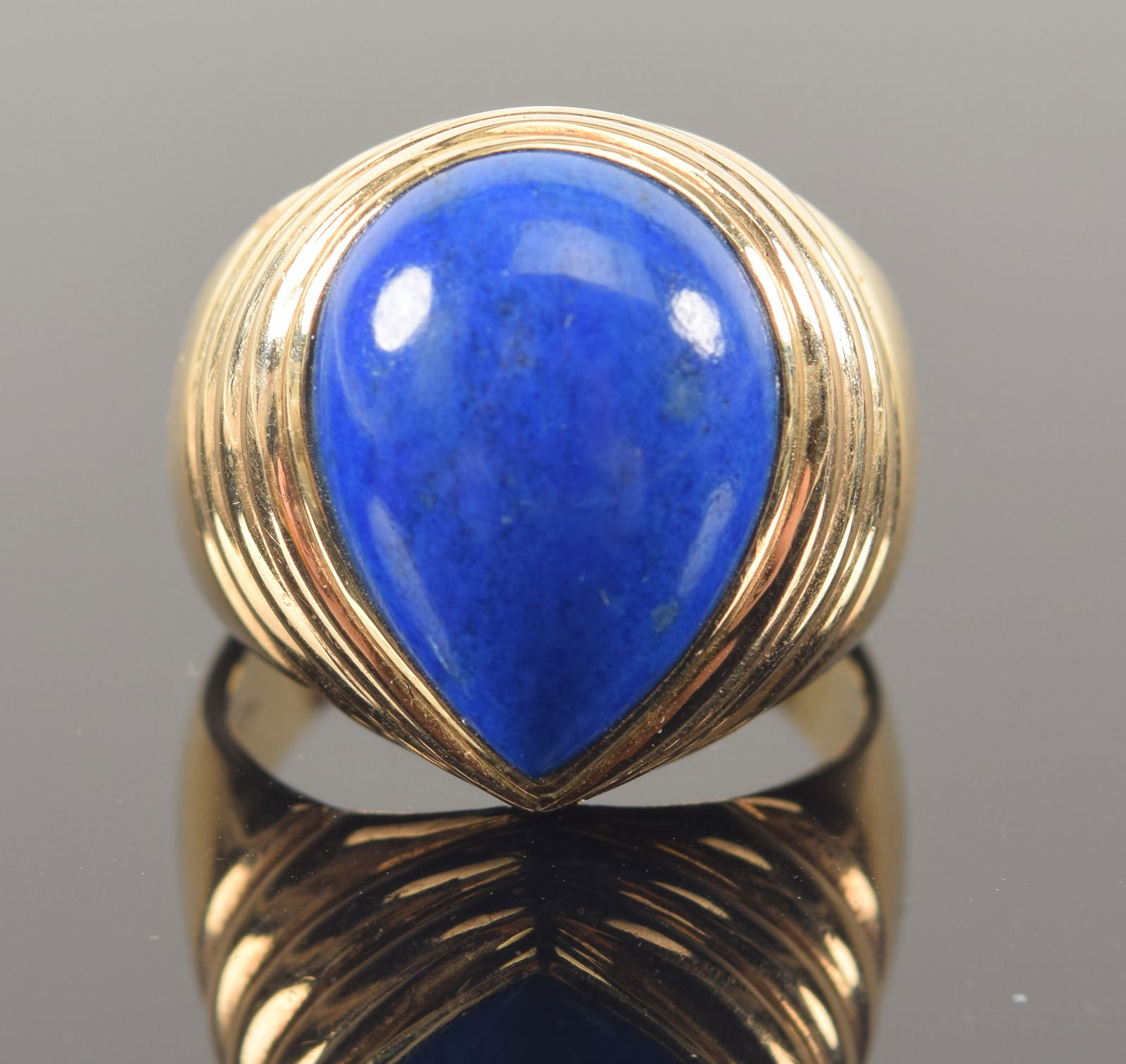 14K gold lapis lazuli mounted ring. Pear shaped stone in concentric bands gold setting. Marked 14K. (1 of 6)