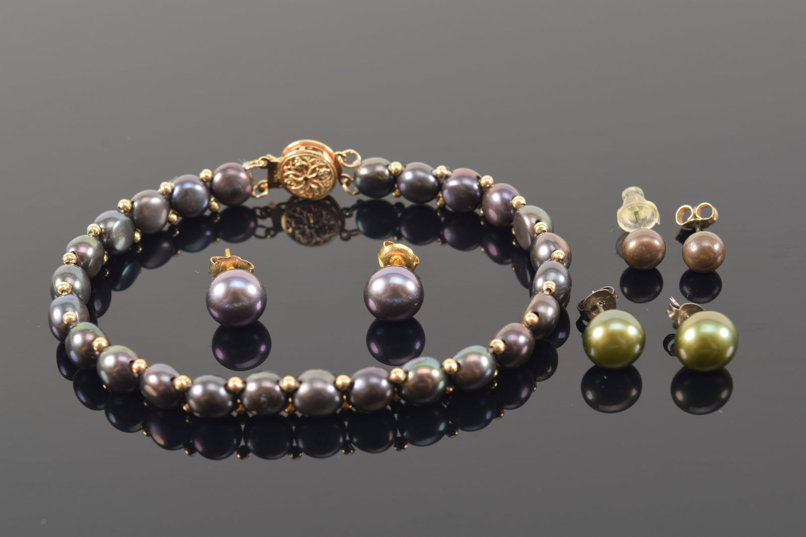 14K gold pearl bracelet and 3 pairs of earrings. Bracelet 7in length. 14K gold clasp. (1 of 5)