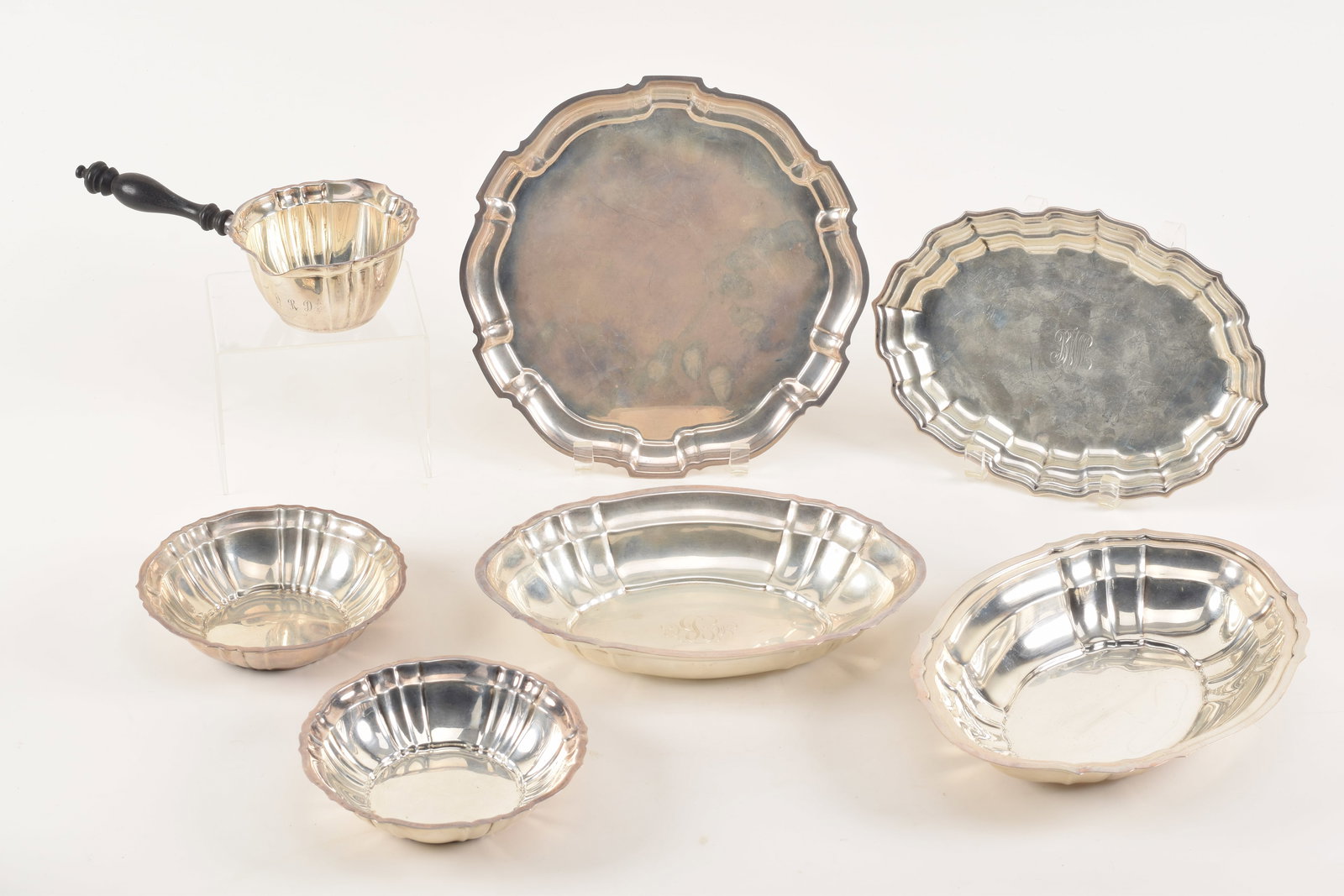 Collection of Chippendale pattern sterling silver tableware including two bowls, 2 graduated oval: Collection of Chippendale pattern sterling silver tableware including two bowls, 2 graduated oval bowls and a handled ladle by Gorham, together with an oval tray by Frank Smith and a round tray by Poo