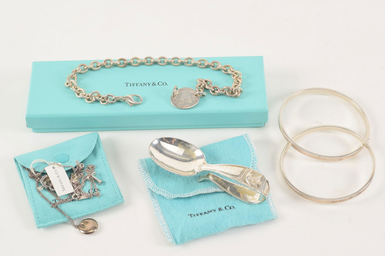 Lot of Tiffany & Co. sterling silver items. 1) Elsa Peretti charm necklace. 2) Interlaced bangle (1 of 5)