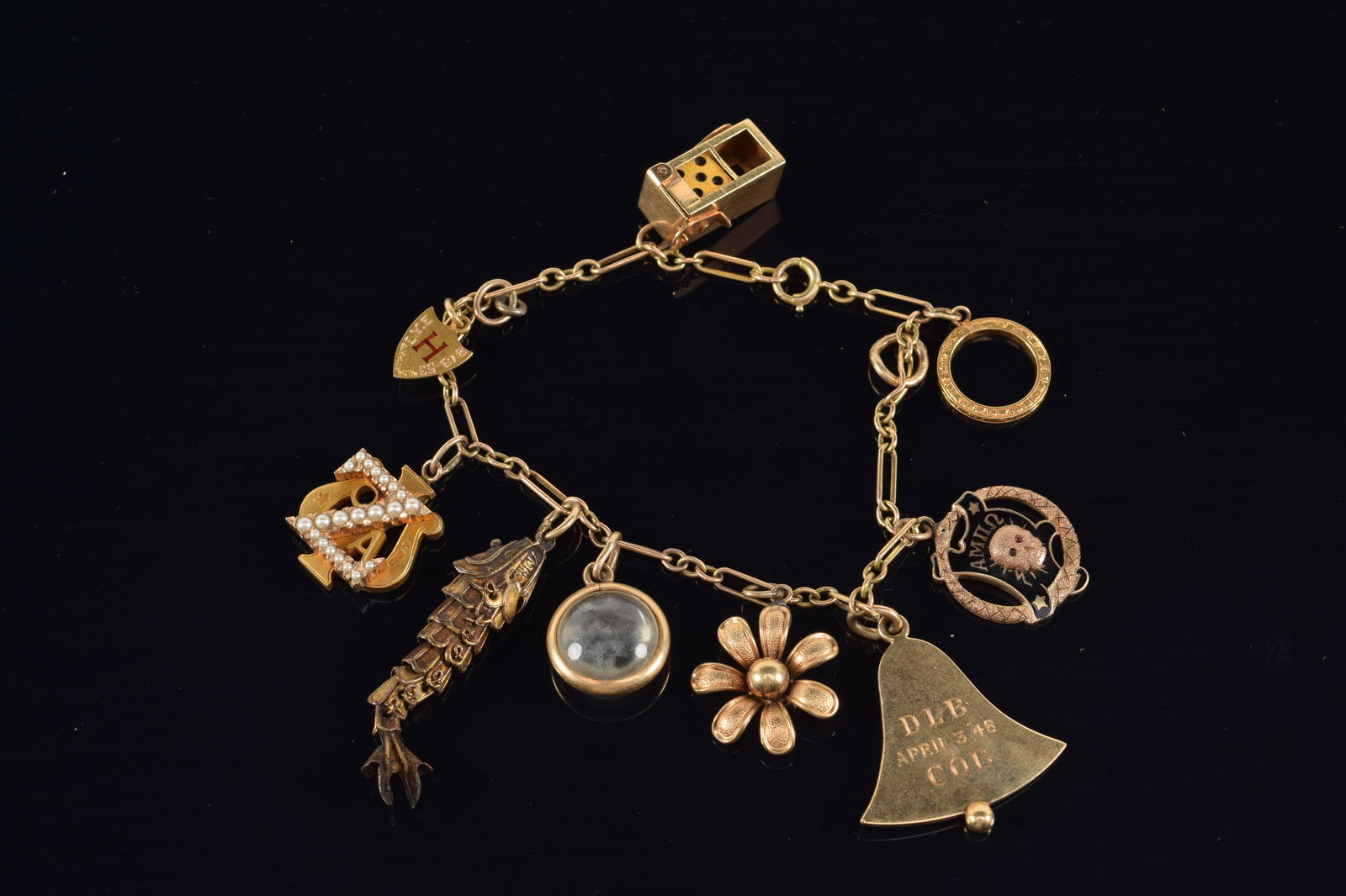 Vintage gold charm bracelet. Mix of 10K and 14K charms. 14K charms include: bell and dice container. (1 of 4)