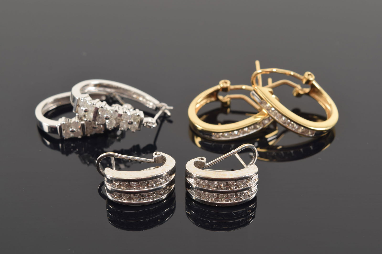 3 pairs of gold diamond earrings. 1) 2 14K gold huggie earrings. 8.5 grams. 2) 10K earrings with (1 of 4)