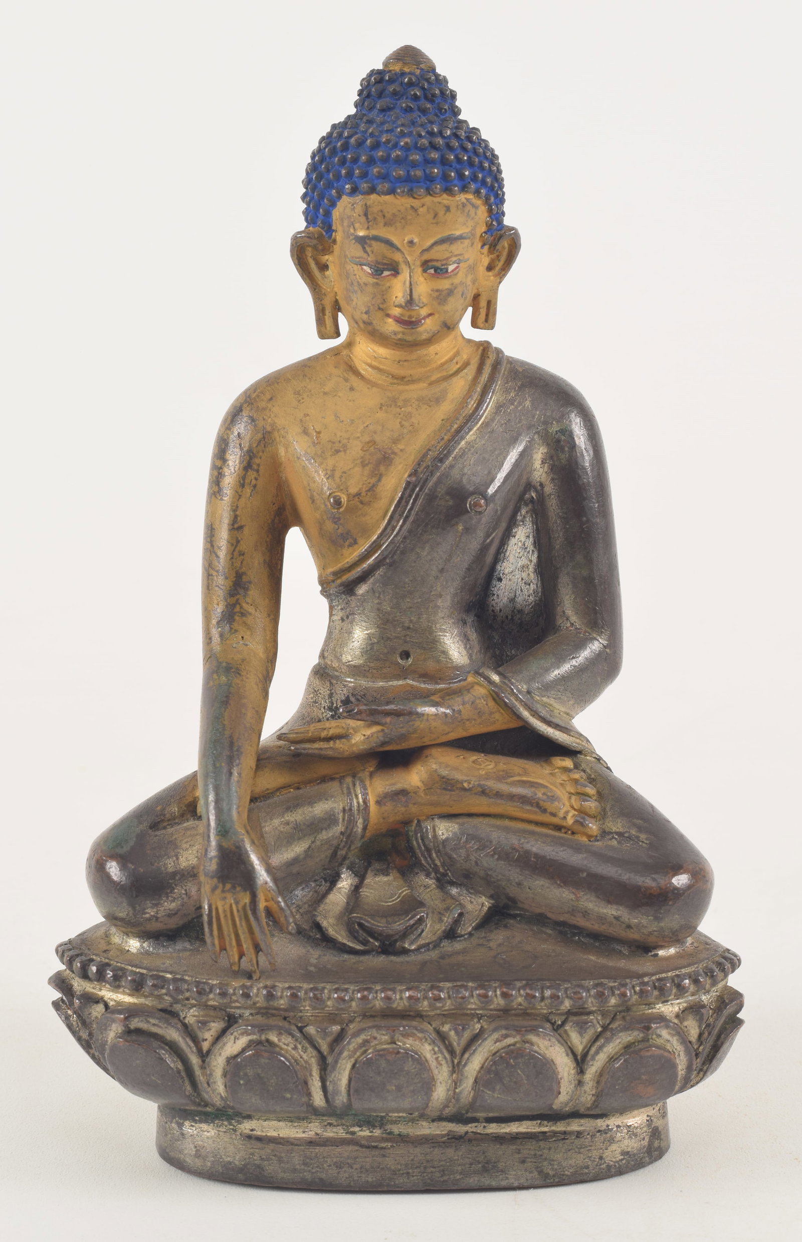 19th century silvered bronze image of the Buddha with cold gold paste applied to face and arms.: 19th century silvered bronze image of the Buddha with cold gold paste applied to face and arms. Sino-Tibetan. Seated figure of Amida and the earth-witnessing mudra. 5.75in high.