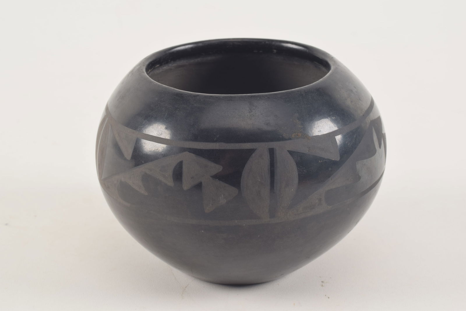 Maria and Julian Martinez. San Ildefonso blackware pottery jar. Matte geometric decoration. Signed (1 of 5)