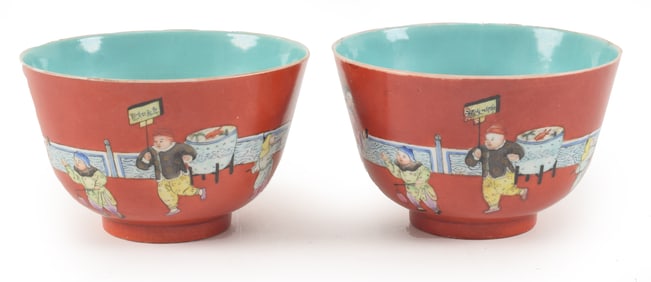 Pair of porcelain bowls. China. 19th century. Famille rose decoration of children on a brick red