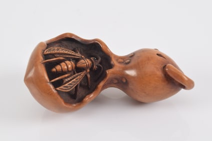 Carved wooden netsuke. Japan. 19th century. Nagoya school. Wasps feeding ravenously upon a rotted sq