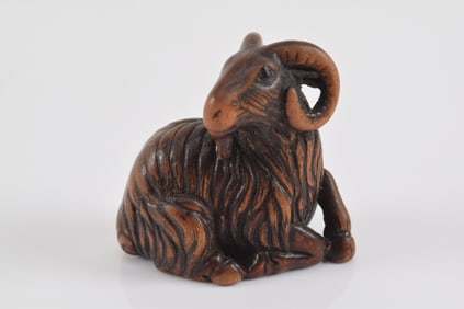 Carved wooden netsuke. Japan. 19th century. Masterfully carved wood goat with individually carved pl