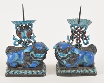 Pair of pricket candlesticks. China. 19th/early 20th century. Foo dog form surmounted by a buddhist