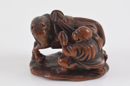 Carved wooden netsuke. Japan. 19th century. Nagatsugu. Groom brushing a horse. 4 x 5cm.