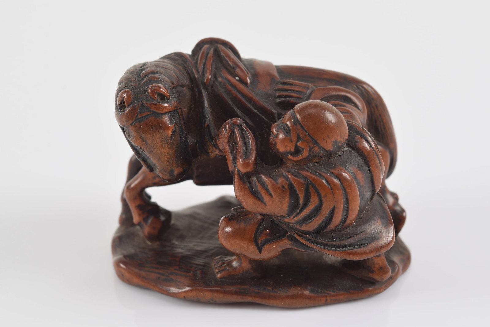 Carved wooden netsuke. Japan. 19th century. Nagatsugu. Groom brushing a horse. 4 x 5cm. (1 of 5)
