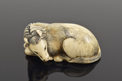 Netsuke. Japan. 19th century. Masayoshi - Tokyo. Recumbent horse. Naturalistically rendered. 5 x