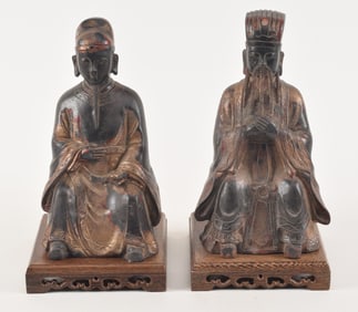 Pair of seated bronze court officials. 20th century. Elder statesman holding a palette and the