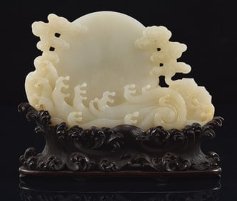 Jade carving. China. Study of the sun rising above the waves and clouds. Hardwood fitted wave carved