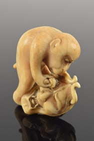 Netsuke. Japan. 19th century. Masatomi. Monkey chisels a Hannya mask. 5 x 5cm.