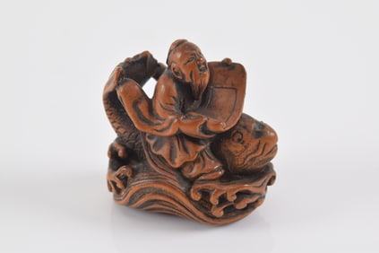 Carved wooden netsuke. Japan. 19th century. Sennin kinko riding the giant carp holding a magic scrol