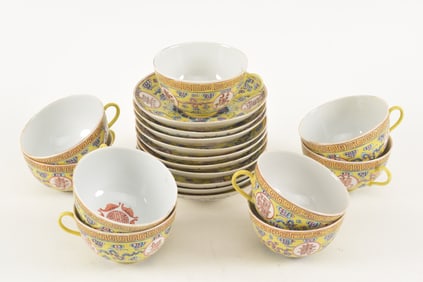 Porcelain cups and saucers. China. Yellow ground decorated with auspicious symbols and clouds. Kuang