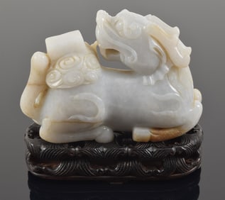 Jade carving. China. 20th century. "Dragon Horse" Lung Ma of grey jade with russet markings. Fitted