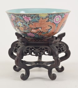 Porcelain bowl. China. Ca. 1900. Decoration of a dragon and phoenix on a mille fleur strewn black