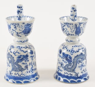 Pair of porcelain candle prickets. China. 19th/early 20th century. Underglaze blue decoration of