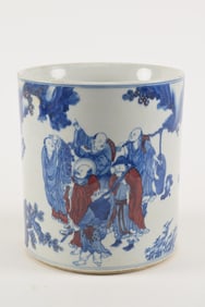 Porcelain brush pot. China. 20th century. Underglaze blue and red decoration of buddhist saints. 8.5