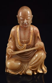 Soapstone carving. China. 19th century. Seated arhat with gilt accents. 4in high.