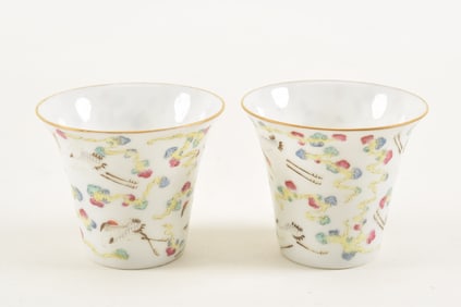 Pair of porcelain wine cups. China. Late 19th century. Bucket shaped. Famille rose decoration of
