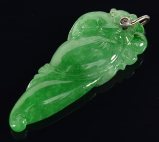 Jadeite pendant. Bright green color. Carved as a pepper with foliage. 1.5in length.
